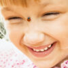 Cute little girl with ladybird on her nose