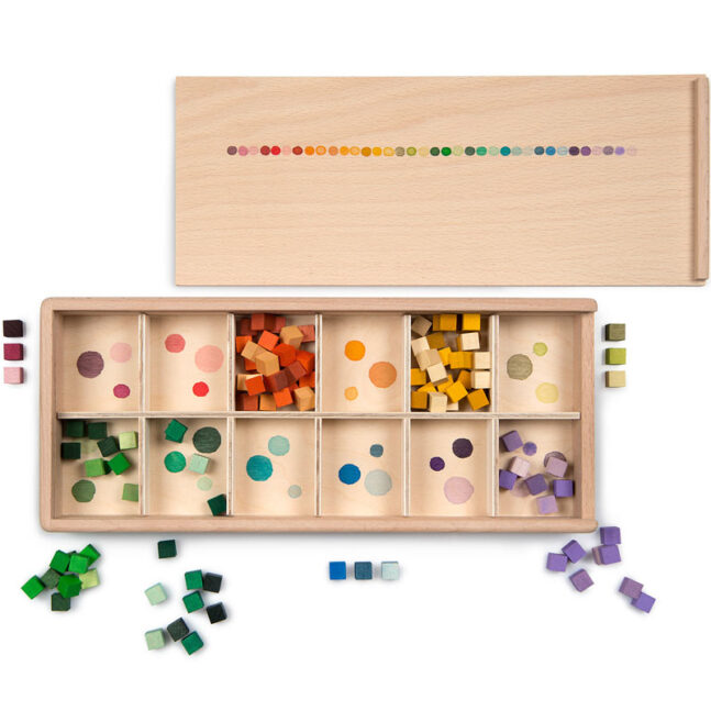 ‘Mis and match’ is a collection of colourful cubes in a wooden sorting box.